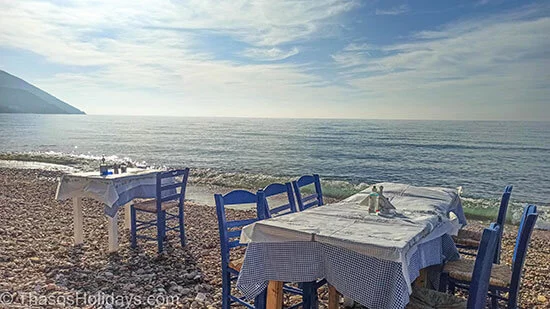 Klisma taverns eat right by the beach on top of pebbles with the waves centimeters away