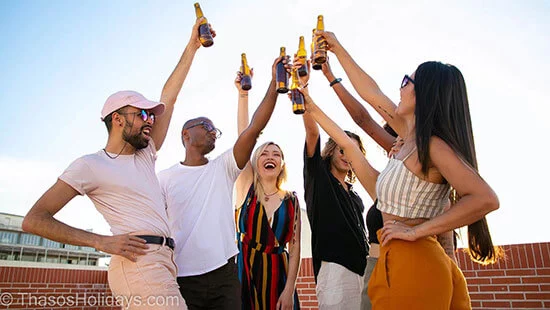 People celebrating with cheering with their drinks