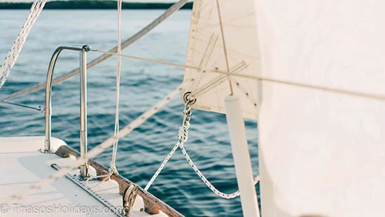 Sailing on a sailing boat in a clean day with views over the land beyond